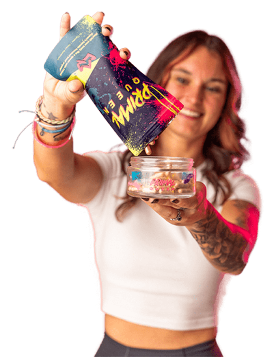 The Primal Queen founder pouring capsules from a product pouch into a jar